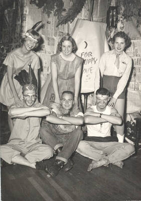 Unidentified greek residents dressed in Native American inspired clothing pose for a group photo.