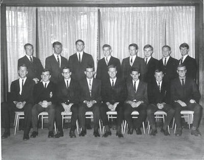 Members of the Beta Theta Pi fraternity pose for a group photo with their House Mother Mrs. Cummins in their house.
