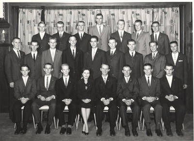 Members of the Beta Theta Pi fraternity pose for a group photo with their House Mother Mrs. Cummins in their house.