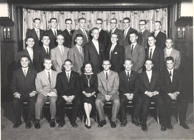 Members of the Beta Theta Pi fraternity pose for a group photo with their House Mother Mrs. Cummins in their house.