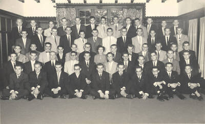 Members of the Beta Theta Pi fraternity pose for a group photo with their House Mother Mrs. Cummins in their house.
