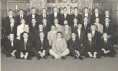 Members of the Beta Theta Pi fraternity pose for a group photo with their House Mother Mrs. Cummins in their house.