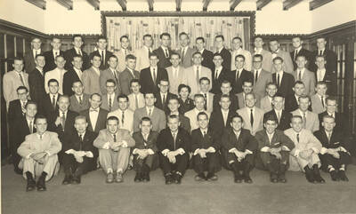 Members of the Beta Theta Pi fraternity pose for a group photo with their House Mother Mrs. Cummins in their house.