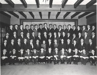 Members of the Beta Theta Pi fraternity pose for a group photo with their House Mother Mrs. Cummins in their house.