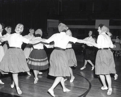 Women dance in concentric circles during the folk dance festival.