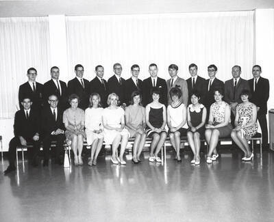 Members of Phi Beta Kappa honorary society pose for a group photograph. Individuals identified as listed. Front: Glenn Nichols, Floyd C. Tolleson, Jr., Eleanor Gittins, Brooke Clifford, Emma Sawyer, Patty McCollister, Margaret Heglar, Michael Jean Skok, Lucy Inouye, Jean Monroe, Sandra Brown; back: Max Walker, Paul Lynch, Tom Kirkland, Brian Stickney,etc.