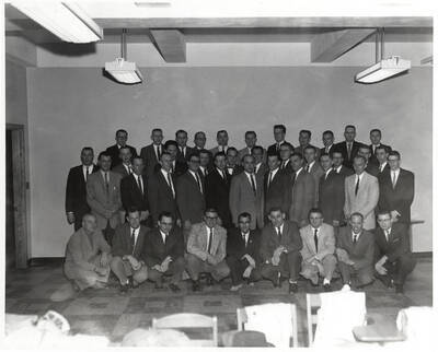 Civil Engineers Club members pose for a group photo together in the back of a classroom.