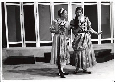 Two women perform on stage in costumes for Summer Theatre in the Kiva.