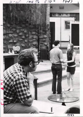 Richard Rohrbacher, Summer Theatre '71 guest director from Skyline College, San Bruno, CA, listens intently as Paul Carey and Barbara Herring rehearse a scene from 'You Can't Take It With You' in the KIVA building.