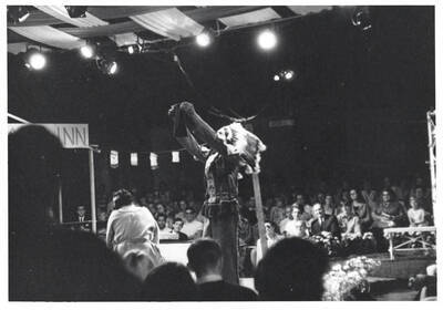 Students dressed as Native Americans perform "Little Mary Sunshine" on a stage in front of an audience. This performance was held in the Field House for Summer Theatre.