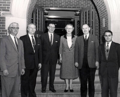 Choral Clinic of Northwest College Directors attendees stand together outside of the Lionel Hampton School of Music. Individuals identified from left to right: Wallace Pefley, Charles W. Davis, Glen Lockery, Ruth Sampson Ayers, Leonard Martin, Joachim Birke.
