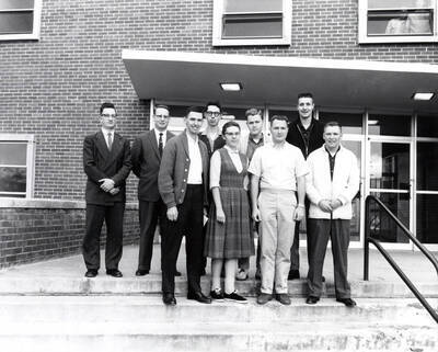 Group photo of the Ag Council standing together on the steps of the Agricultural Science Building. Back: Alfred Slinkard (advisor), Glen Purnell, Harvey Doner, Charles Eugene Allen, Arthur Lee; front: Larry Moore, Yolanda Lewandowicz, Robert Williamson, Darrell Hatfield.