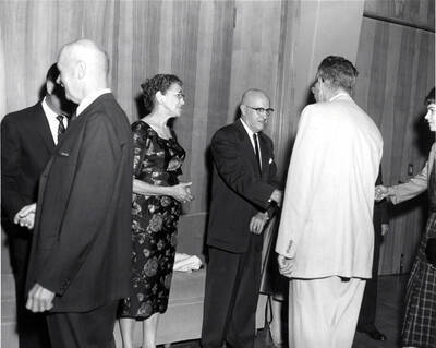 President Donald R. Theophilus and Cora Theophilus shake hands and welcome guests to the faculty reception.