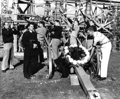 Military student perform a four-gun salute during a ceremony and place a wreath on the Tau Kappa Epsilon cannon.