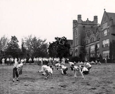 Intramural players line up in formation for a touch football scrimmage.