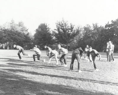 Men line up for a play during an intramural touch football game.