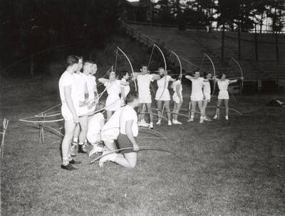 A group of students line up during archery class.