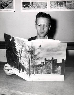 Editor Philip Schnell examines the Gem of the Mountains, which received an All-American rating, the highest award given by the National Scholastic Press Association.