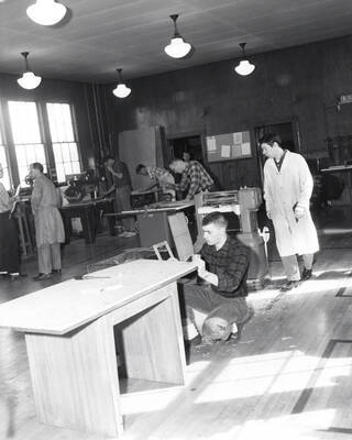 Multiple Industrial Arts Education students work on their projects in a shop.