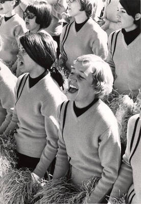 Pom-Pom Girls sit in the stands and cheer on the Vandals.