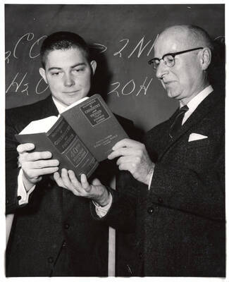 University of Idaho student Howard W. Gerrish Jr. receives the Chemical Pub. Co. freshman achievement award from Dr. Malcolm Renfrew, head of Physical Sciences.