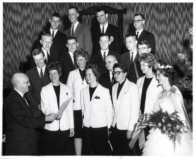President Donald R. Theophilus congratulates the outstanding seniors after their group photograph. Individuals identified as listed. Row 1: Sally Jo Nelson, Claire L. Slaughter, Kristeen Allen Deitz, Sharon Lance, LaDessa K. Rogers; row 2: Herbert Hollinger, Susan Rutledge, William R. Kindley, James Mullen; row 3: Larry Hossner, Robert Schumacker, Peter Kelly, Robert Keller; etc.
