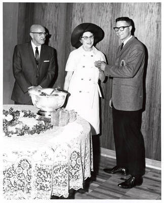 William James Johnston, first winner of the Donald R. and Cora E. Theophilus award, stands with President and Mrs. Theophilus.