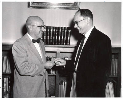 Idaho chapter of Phi Beta Kappa honors President Donald R. Theophilus by making him a member. Professor Fred H. Winkler hands him a key.