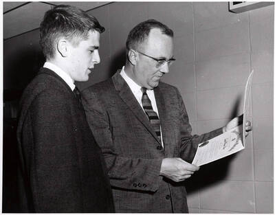 University of Idaho student Carlan William Silha receives a scholarship from American Society for Metals from Dr. Earl Cook.