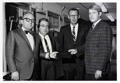 University of Idaho student Richard Sain Kunter receives the J.R. Simplot Co. award, presented by Harry Caldwell, Joseph Newton, and Rolland R. Reid.