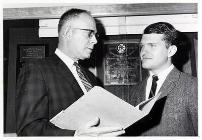 Dwight Hoffman presents University of Idaho graduate student Phil Armstrong with the Phillips Petroleum award.