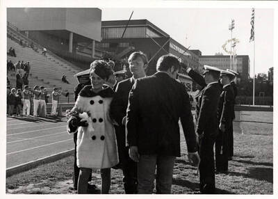 Kathy Jo Jacobs, Miss University of Idaho, walks onto the football field with her escort during Homecoming.