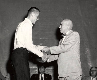 University of Idaho student Thomas L. Anderson receives the Hamilton Watch Company award from President Donald R. Theophilus.