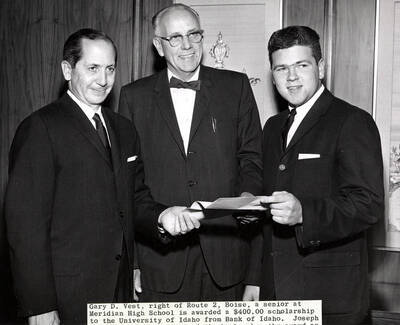 Gary D. Vest, senior at Meridian High School, is awarded a $400 scholarship to the University of Idaho from Bank of Idaho. Joseph Bianco, president of bank, makes the award as John Riddlemoser, center, principal of Meridian High, looks on.
