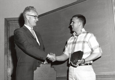 University of Idaho student Donald Fry receives the Outstanding Graduating Engineer Award from Earl Haroldsen.
