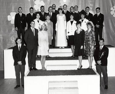 Outstanding Seniors pose for a group photo on a stage before the awards ceremony. Individuals identified as listed. Row 1: Jim Carlson, Mark Smith; row 2: Don Fry, Brooke Clifford, June Lay, Mike Skok; row 3f: Jean Monroe, Helen Black, Margaret Heglar, Judy Rice; row 4: Leo Jeffres, Bob Aldridge, Jerry Decker, Gary Chipman, Robert Stanfield, Margie Felton, etc.