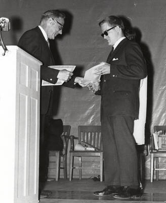 President Ernest W. Hartung congratulates University of Idaho student Robert E. Caron upon receiving the Idaho Congress of Parents & Teachers Certificate of Merit.