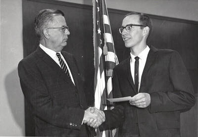 Dean Menard presents the Phi Delta award to University of Idaho student Robert Edward Farnam.