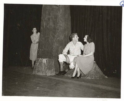 Students from l-r: Shirley Brandt as Joanna Trout, Richard Peterson as Mr. Purdie, and Polly Harris as Mabel Purdie. University of Idaho students act out a group scene for the play, 'Dear Brutus.' An ASUI production directed by Jean Collette in the University of Idaho Auditorium.