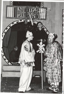 Students from l-r: Tom Butera as Orchestra, Jerry Sperrazzo as Wu Hoo Git, Andy Tozier as Property Man and Duane Ness as Git Hok Gar. The property manager throws pedals over Wu Hoo Git and Git Hok Gar as they speak in Idaho's production of 'The Yellow Jacket.'  An ASUI production directed by Jean Collette in the University of Idaho Auditorium.