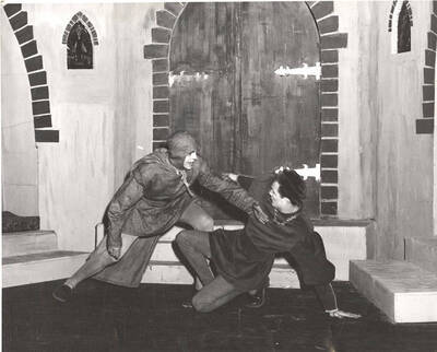 Death, played by Robert Bungting, destabilizes Everyman, played by Normand Green, with a touch in Idaho drama's production of 'Everyman.' An ASUI production directed by Neal Christenson and Harry Dalva.