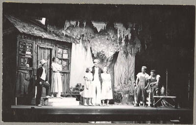 From l-r: Harry Dalva as Commodore, Marie Hargis as Mrs. Crochet, Larraine Cole as Topal, Normand Green as Dewey Crochet, Colleen Christensen as Evvie, Keith Keefer as Elmo, Kenneth Keefer as Fleece. Idaho drama students act out a group scene in the play, 'The Great Big Doorstep.' An ASUI production directed by Jean Collette in the University Auditorium.
