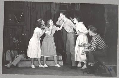 From l-r: Harry Dalva as Commodore, Lorraine Cole as Topal, Colleen Christensen as Evvie, Robert Gartin as Arthur, Marie Hargis as Mrs. Crochet and William Davidson as Mr. Tobin. Every character but Commodore tests out their range in a voice contest in Idaho drama's production of 'The Great Big Doorstep.' An ASUI production directed by Jean Collette in the University Auditorium.