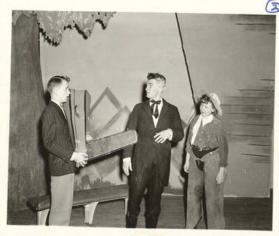 Performers from l-r: Maurice Paulsen as Phil Gregory, Otis Walter as Senator Singleton and Betty Smith as Ma Randall. Phil Gregory and Sen. Singleton look at each other in surprise in Idaho drama's production of 'Sing, Singleton, Sing.' An ASUI production written by Geoffrey Coope, Theodore Sherman, & music Hall Macklin (all UI teaching faculty), directed by Jean Collette in the University Auditorium.