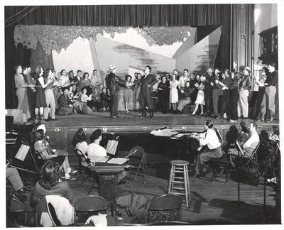 Idaho drama students rehearse the ending of the play, 'Sing, Singleton, Sing.' An ASUI production written by Geoffrey Coope, Theodore Sherman, & music Hall Macklin (all UI teaching faculty), directed by Jean Collette in the University Auditorium.