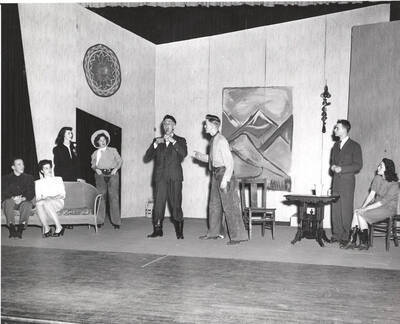 Idaho drama performers act out a group scene during production of the play, 'Sing, Singleton, Sing.' An ASUI production written by Geoffrey Coope, Theodore Sherman, & music Hall Macklin (all UI teaching faculty), directed by Jean Collette in the University Auditorium.