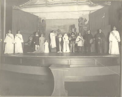 A group scene of Idaho drama's production presented by the English Club of the play, 'Everyman.' Every character is pictured on stage. Presented by the English Club, directed by Henrietta E. Moore