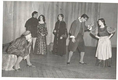 Students from l-r: Ron Baker, Paul Matthews, Beverly Alger, Frank Miles, Larry Hyer, Sharon Henderson. Idaho drama students act out a group scene in the department's production of the play, 'The Doctor In Spite of Himself.' Directed by Margaret Magee in the south ballroom of the Student Union Building.