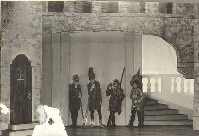 Background actors can be seen smiling in Idaho drama's production of "Romeo and Juliet." Adapted by Talbot Jennings, directed by John Cushman in the University Auditorium.