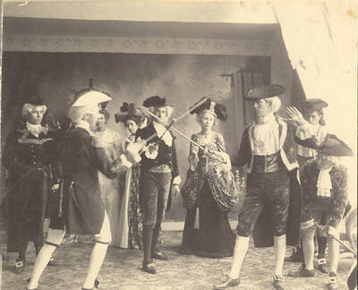 Students from left to right: Burton French, Homer David, Mabel Martyn, Edna Moore, Fred McConnell, Anna Edna Clayton, William Lee, John McConnell, Ben Oppenheim. Homer David and William Lee sword fight in Idaho drama's production of "The Rivals." Directed by Aurelia Henry.